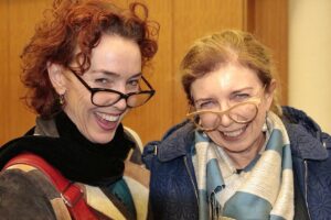 2 women with large glasses laughing
